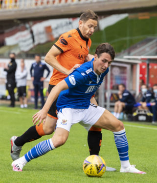 Danny McNamara shields the ball from Dundee United's Peter Pawlett.