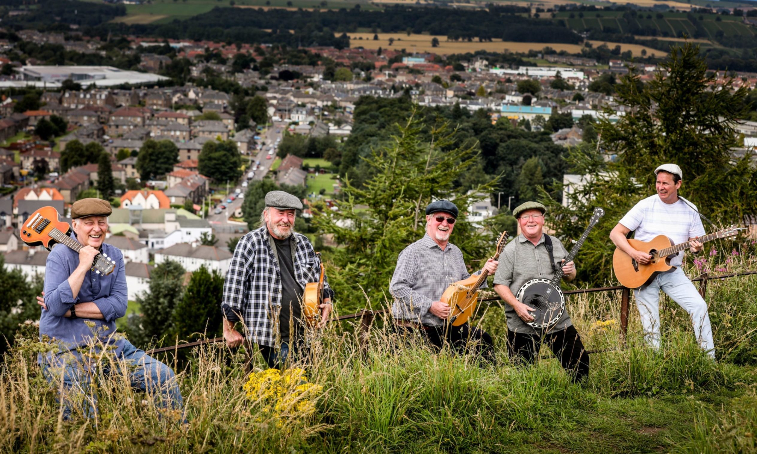 Ian Kennedy and his bandmates at the top of the Law looking over the schemes of Dundee.