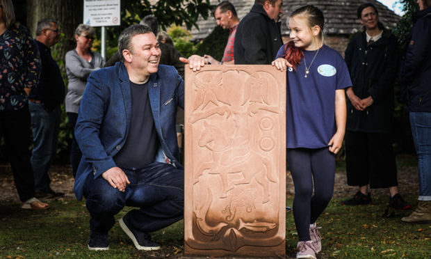 Sculptor David McGovern and litter picking champion Lily Souter who officially unveiled the stone.