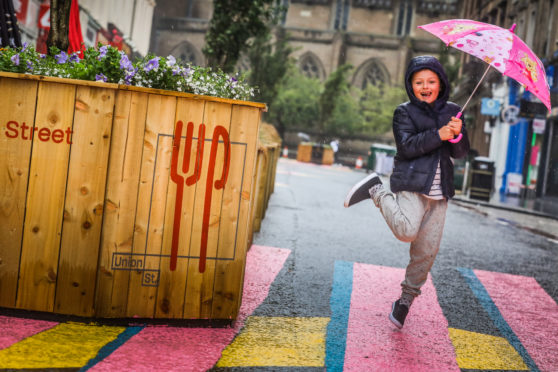 Tyler Fisher, 6, doesn't let the storm dampen his spirits on Union Street.