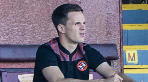 An injured Lawrence Shankland watches his teammates from the stand..