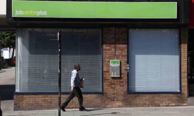 A man walks past a job centre.