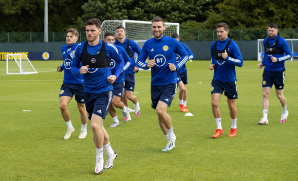 Captain Andy Robertson leads the Scotland squad in training.