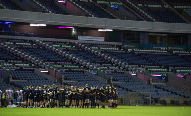 The Edinburgh players huddle at full time after defeat to Ulster in the PRO14 semi-final.