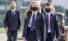 School pupils wear masks to classes.