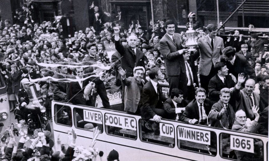 Big Ron Yeats holds aloft the 1965 FA Cup on the victory bus, flanked by Bill Shankly.