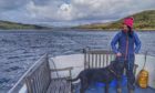 Gayle and her dog Toby enjoying a boat trip around the Isle of Carna.