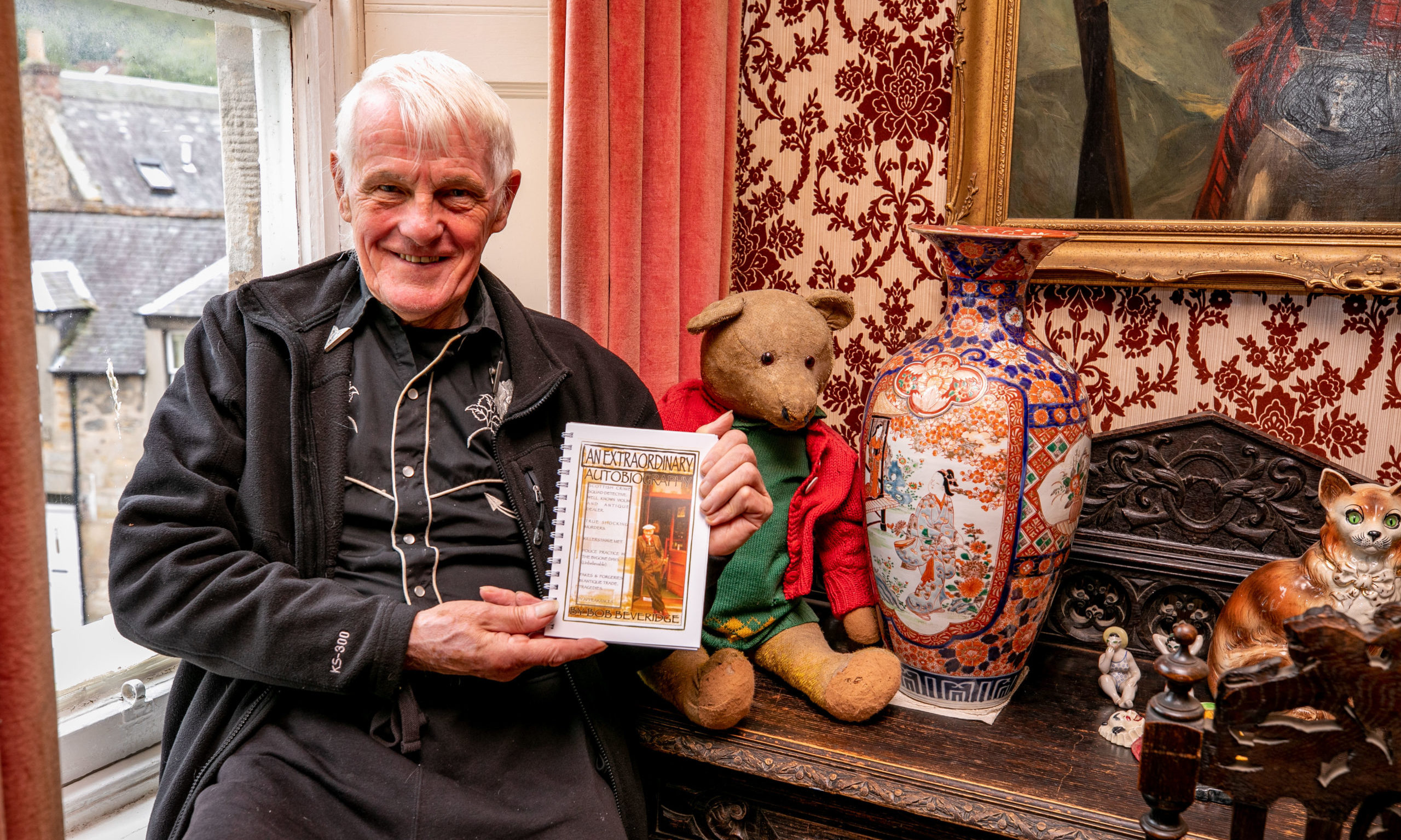 Retired detective and Violin Shop owner Bob Beveridge with copies of his new book 'An Extraordinary Autobiography'