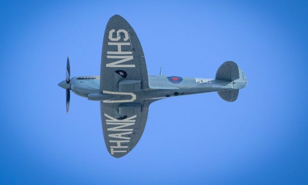 The "Thank You NHS" Spitfire flies over the Royal Infirmary of Edinburgh.