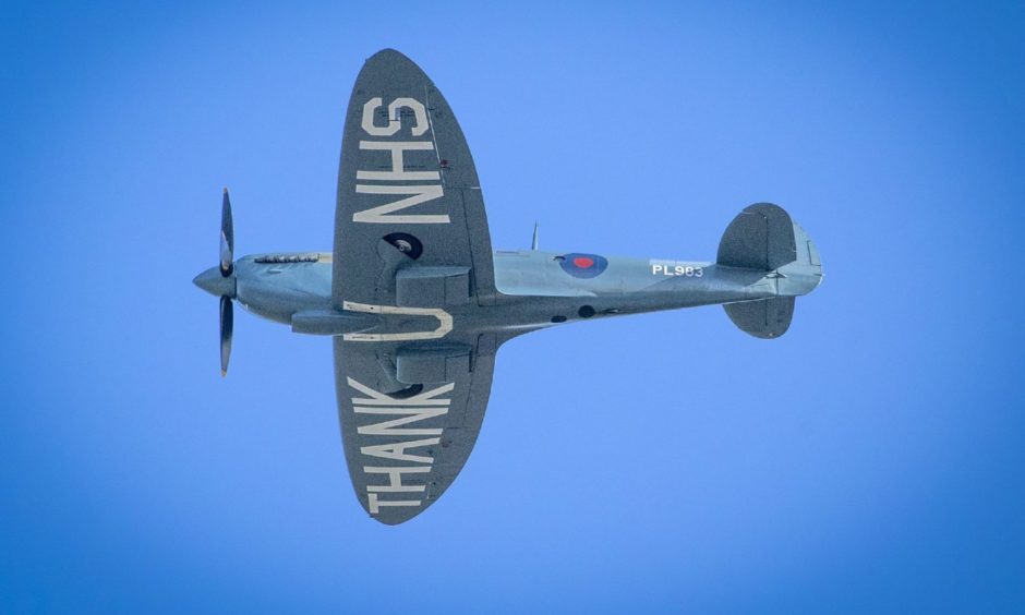 The "Thank You NHS" Spitfire flies over the Royal Infirmary of Edinburgh.