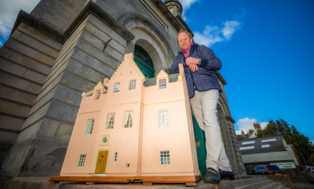 Auctioneer Nick Burns with the scaled down fortress