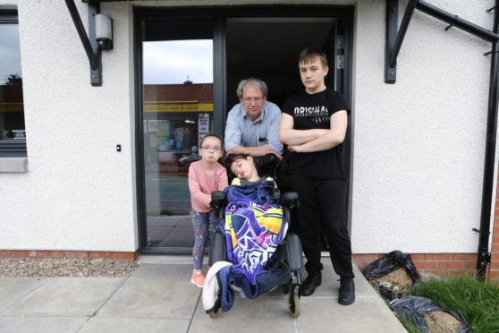 Allan Petrie at home in Dundee, with his grandchildren Megan Sinclair, 11, Ronald Sinclair,13, and Poppy Petrie, 5, have all been in isolation