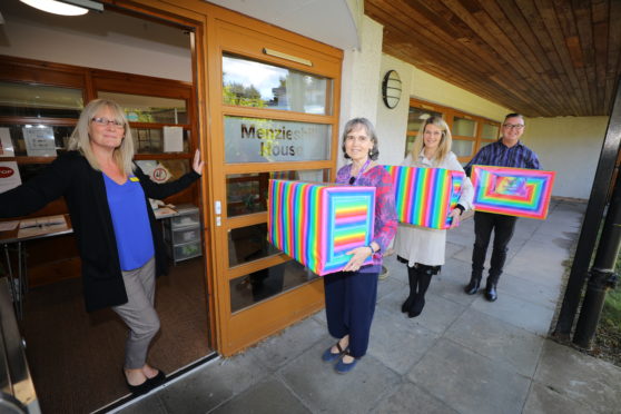 Rainbow Boxes being delivered to Menzieshill House.
Ashley Grays, (left) senior social care officer at Menzieshill House, receiving the boxes from Lorna Donnelly, Emma Jane Wells and Richard McIntosh of the Tayside Health Fund.