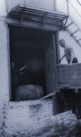 Workers transporting casks.