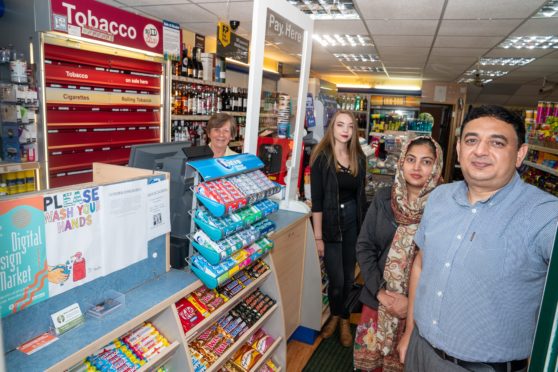 Irfan Asghar is pictured with his wife Tanzeela and staff June Allan, left, and Alana Ferns.