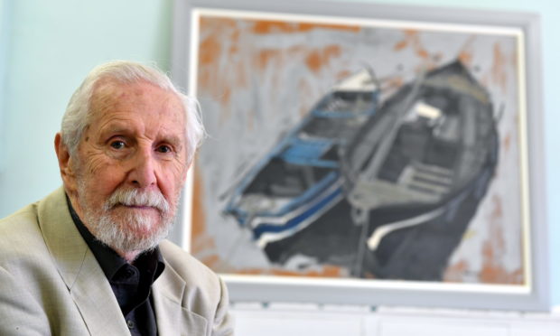 Artist James Morrison in 2018 with a fishing boat painting that has hung in Catterline School for decades.