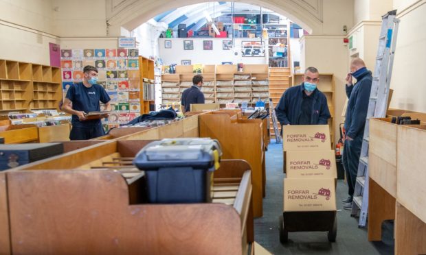 Staff from Forfar Removals take on the job of emptying Groucho's Music Store.