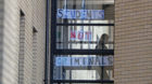 A student walks past a sign at Murano Street Student Village in Glasgow,