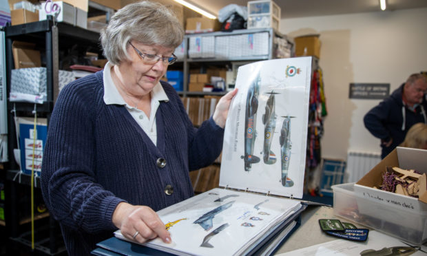 Gill Howie with her master collection of signed prints including one commemorating the Battle of Britain Memorial flight which is signed by Vera Lynn.