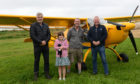 Pilot Martin Petrie and daughter Lucy (8) with farmer Andrew Stirling (left) and MAHSC chairman Stuart Archibald. Pic: Neil Werninck.