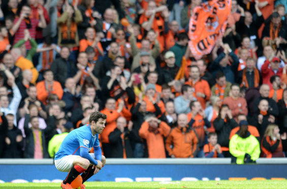 A dejected Richard Foster in front of elated Dundee United fans the last time United played Rangers at Ibrox.