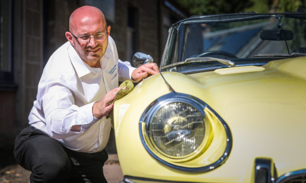 Classic Restorations managing director Graeme Johnstone with a 1974 Jaguar Series 3 B-12 E-type.