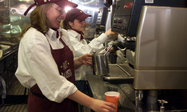 A Pret A Manger barista prepares a coffee.