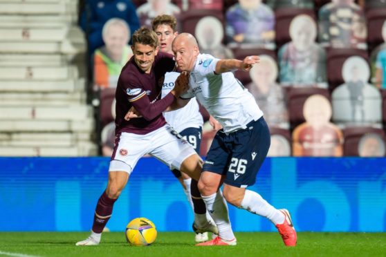 Charlie Adam battles with Olly Lee in Dundee's defeat to Hearts.