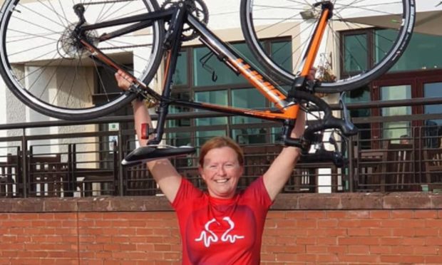 Triumphant charity cyclist Claire Penman at the Carnoustie finish line.