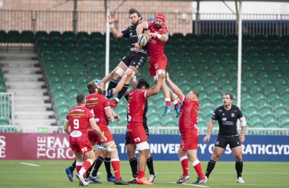Scarlets' Blade Thomson fights for lineout ball with Ryan Wilson at a spectator-less Scotstoun.