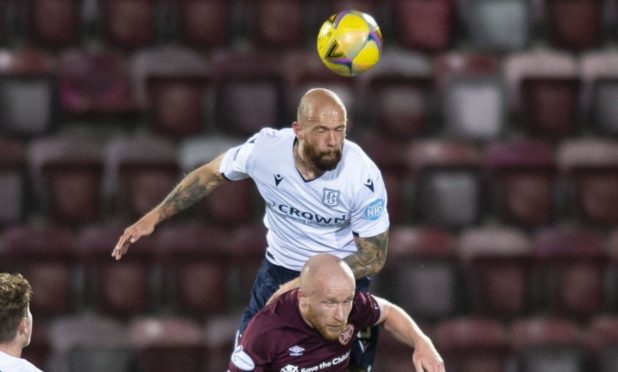 Dundee's Jordan Forster wins a header against Hearts' Liam Boyce.