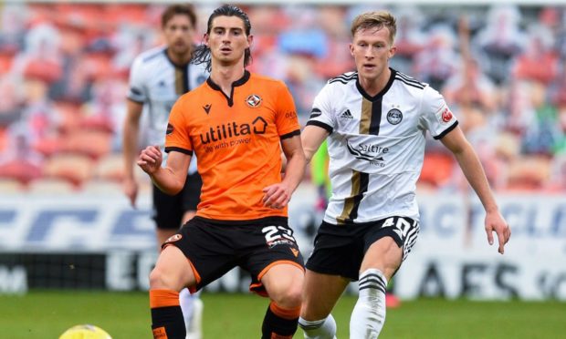 Ross McCrorie of Aberdeen closes in on Dundee United midfielder Ian Harkes.