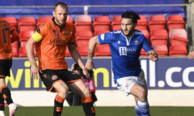 Dundee United skipper Mark Reynolds chases St Johnstone winger Craig Conway.