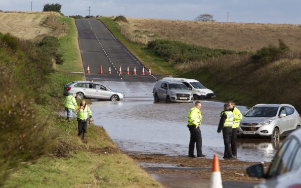 Vehicles stranded on the A92 between Arbroath and Montrose near Inverkeilor after severe flooding.