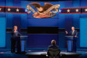 President Donald Trump, left, and Democratic presidential candidate former Vice President Joe Biden, right, with moderator Chris Wallace, center, of Fox News during the first presidential debate on Sep 29