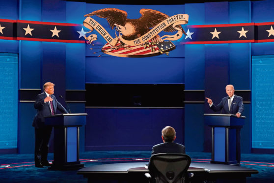 President Donald Trump, left, and Democratic presidential candidate former Vice President Joe Biden, right, with moderator Chris Wallace, center, of Fox News during the first presidential debate on Sep 29