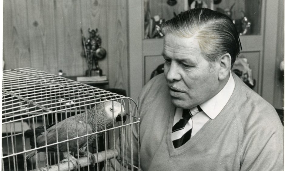 Jockie with one of his African parrots.