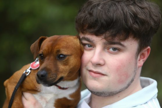 Ally McLaren at home near Blairgowrie today, reunited with his dog Harvey, which was found more than 400 miles away.