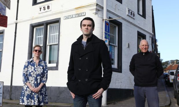 Rhuaraidh Fleming with fellow protestors Findlay McLaren and Rhona McLaren at the Anstruther TSB branch.