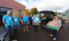 Volunteers from Dundee Bairns, with Cllr Lynne Short and staff from Tayside Contracts about to load up the food for distribution, at the Coldside Community Campus in Dundee.