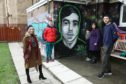 From left: Dawn Mullady, manager of the Pitstop Project, Caleb Fegan, friend of Harry, Ashley Carle, Harry's mum, Kalel Carle Harry's brother, and Nathan Hayes - friend of Harry, beside the new mural of Harry, by Sykes, at the Pitstop Project in Forfar.