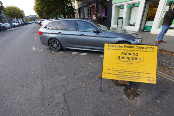 A sign in St Andrews warning of parking restrictions for the Spaces For People measures.