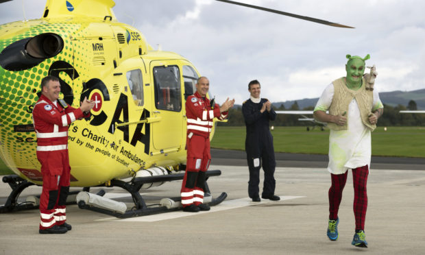 Helicopter pilot Dave Young completed his sponsored 13km run around Perth Airport, raising money for SCAA.