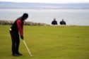 Aaron Rai putts watched by tournament spotters on the first day of the Scottish Championship.