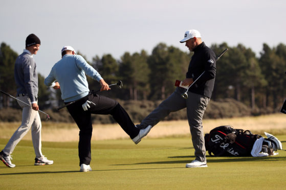 England’s Lee Westwood (right) and Ian Poulter bump feet after finishing their second round at The Renaissance.