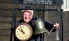 Montrose Air Station Heritage Centre chairman Stuart Archibald with the station clock and scrambling bell of the era.