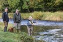 Dr Craig MacIntyre of the Esk District Salmon Fishery Board, estates riverman Donald Webster and local angler Jean Marshall on the Kinnaird beat of the River South Esk.