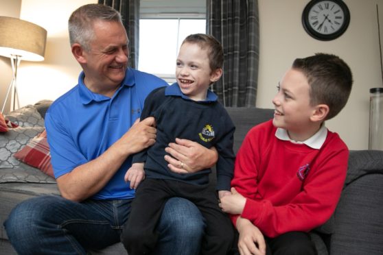 Four-year-old Fife youngster Cameron Gilmour with dad, Jim and brother, Scott,11.