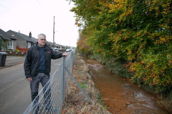 Mark Watters outside his home which was one of several devastated by flood water.