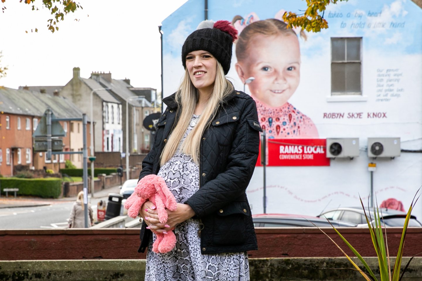Danielle Falconer in Townhill, with the memorial mural in the background. 